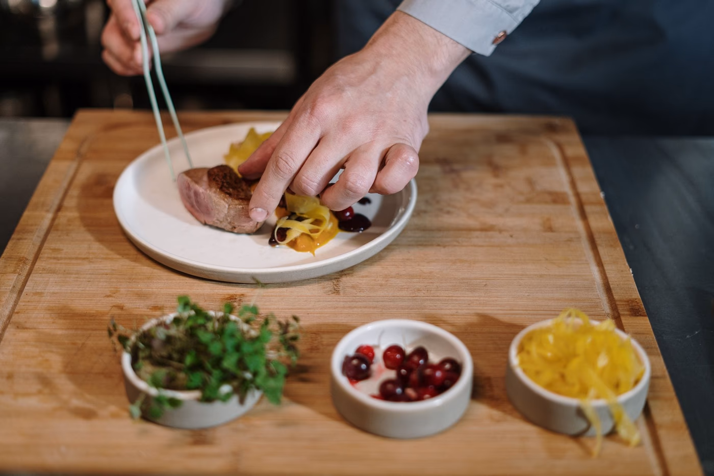 Consulting chef tasting a carefully plated dish in a Montreal restaurant kitchen