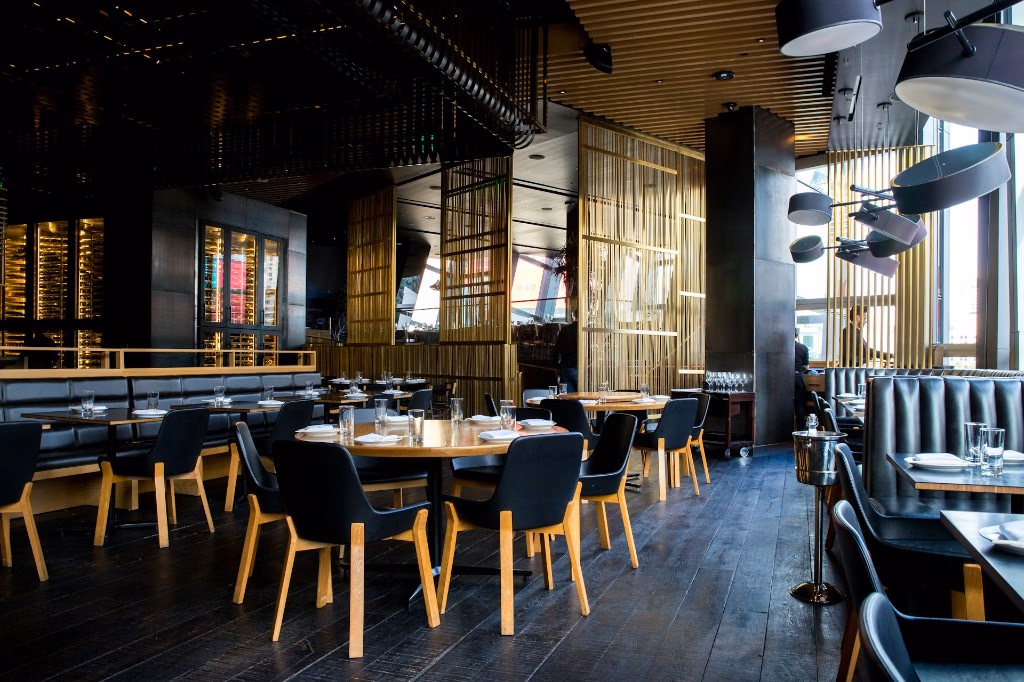 contemporary restaurant dining room with set tables and black chairs