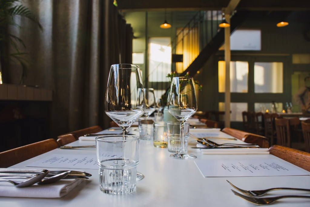 set restaurant table with wine glasses and printed menus