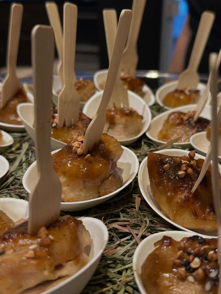 Close-up of glazed bites with wooden forks